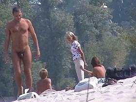 Perky breasted nude beach MILF filmed by a voyeur