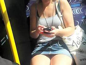 Upskirt sights of a girl texting in the bus