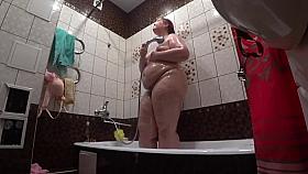 Lesbian has installed a hidden camera in the bathroom at his girlfriend. Peeping behind a bbw with a big ass in the shower. Voyeur.