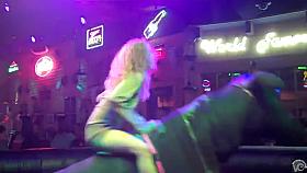 Riding the mechanical bull uncovers blonde's sexy ass