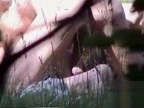 Outdoor sex filmed through the bushes by a voyeur