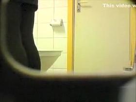 Girl in leggings peeing in toilet