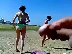 Ejaculating on a topless woman on the beach