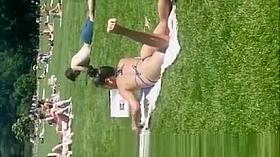 Exotic girl in small bikini at park