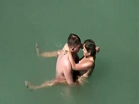 Adorable woman has steaming hot sex in the water