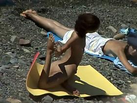 Nudist girl caught doing beach yoga