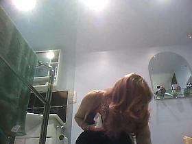 Sexy milf looking around when pissing on the toilet