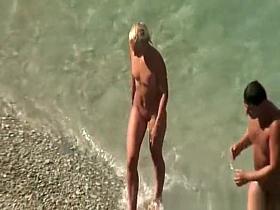 Couple undressing in beach