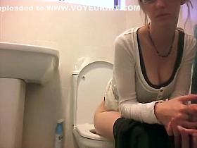 Girl in glasses spied taking a piss