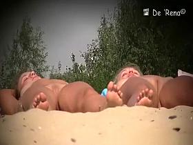 Two nude girls sunbathing