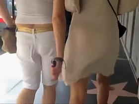 Her white dress shows her black thong