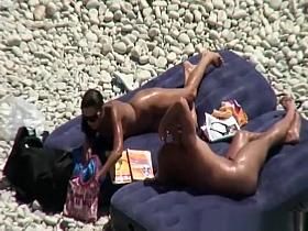 Nudist brunette woman sunbathing
