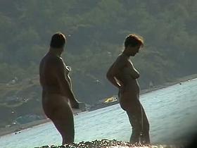 Several sexy nude girls caught on a beach with a spy cam