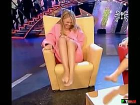 A sexy blonde woman shows off her feet in a TV show