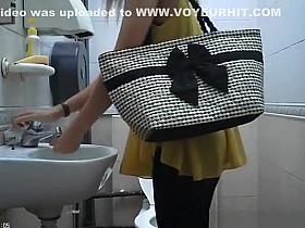 Woman in yellow blouse spied in toilet