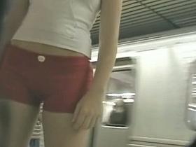tight red shorts street candid waiting for the tube train