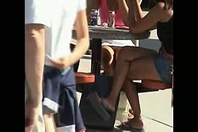 2 white babes resting on a bench in an upskirt vid showing their panties
