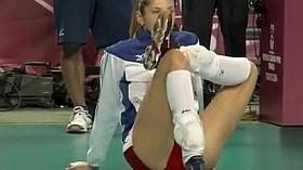 Leggy volleyball girl stretches before a match