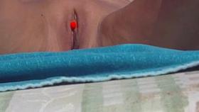 Pierced clit on the beach