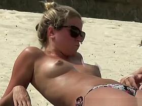 Topless blonde teen with small boobs at beach