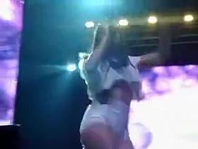 Scantily clad Spanish singer on a stage reveals her great booty