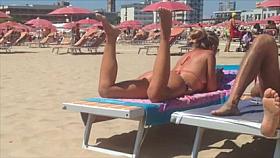 Round tan arse on the beach