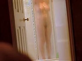 Girl in shower washes and does not see to be voyeured