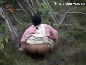 Indian women pissing in the grass in voyeur video