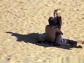 Blonde girl rides her boyfriend’s dick in beach