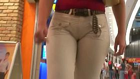 Street booty voyeur catches a woman flexing her butt in tight jeans