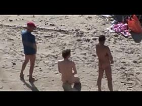 Voyeur on public beach. Group sex before spectators