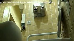 Sideways view of a woman spied pissing