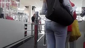 Woman squats exposing thong