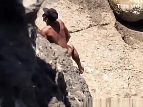 Couple spied in rocky beach having sex