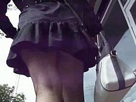 Sexy ladies in black skirts filmed outdoors in the upskirt action