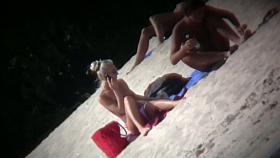 Nude beach blonde model being filmed by a voyeur