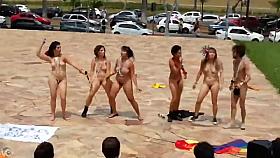 Naked singing and dancing girls put on a public show