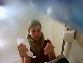 Girl with chubby hips is pissing on toilet before spy cam