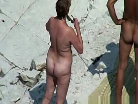 Chubby mature nudist woman at beach