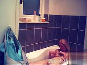 Foxy blonde with perky tits enjoys masterbating in the bathroom
