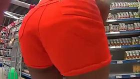Nice girl with bubble ass in orange shorts