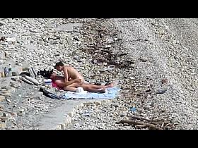 Couple fucked on a public beach while as people walked near