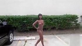 Black girl walks naked through apartment courtyard