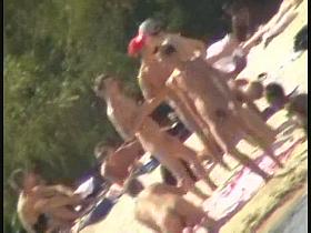 Blonde naked babe with shaved pussy on public beach nudist exposure