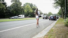 Gorgeous brunette shows off her legs on the street