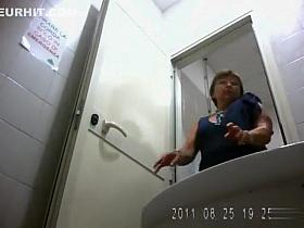 Mature woman urinates standing up