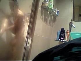 Naked beauty showering body before the hidden cam