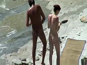 Nudist couple sunbathing and refreshing