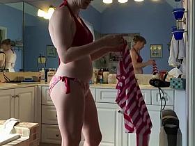 Woman caught taking off her red bikini