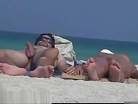 A sexy model couple on the beach voyeur video
